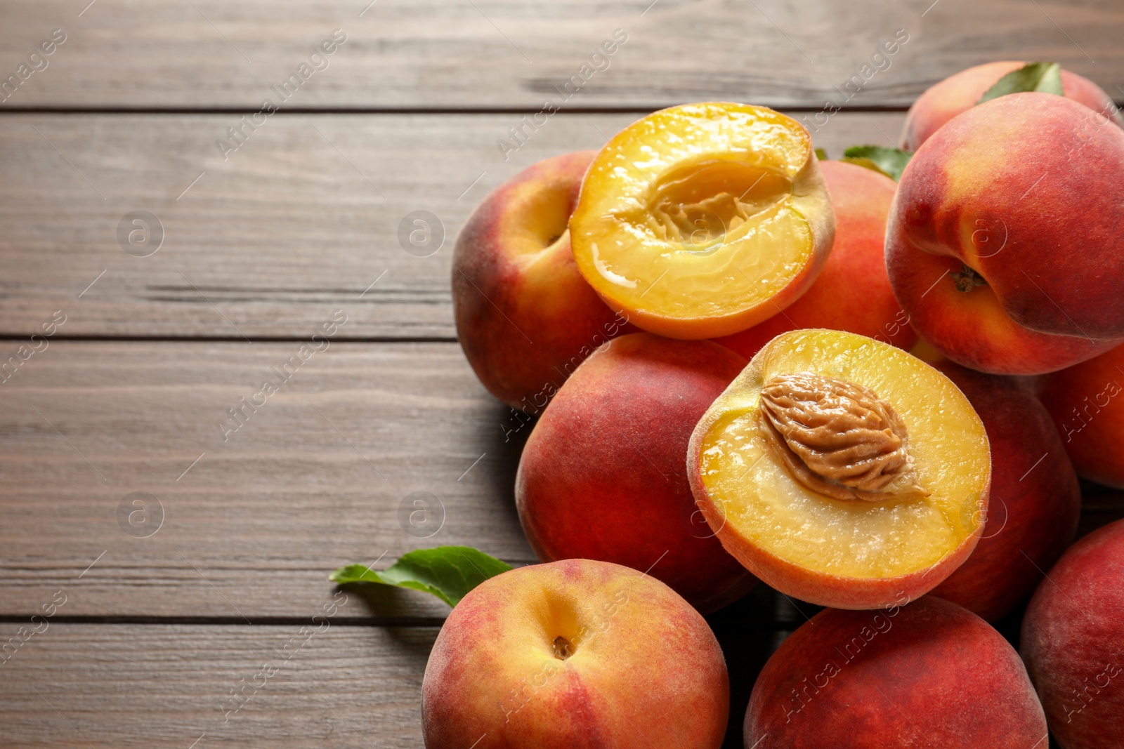 Photo of Fresh sweet peaches on wooden table, closeup