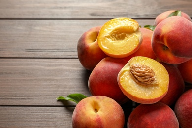 Fresh sweet peaches on wooden table, closeup