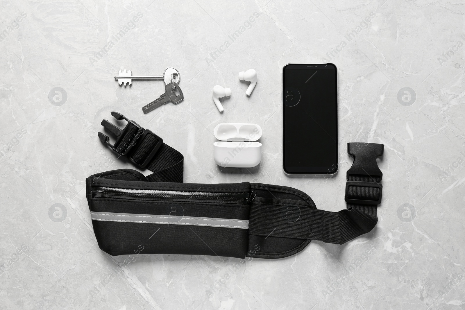 Photo of Flat lay composition with black waist bag on light grey table