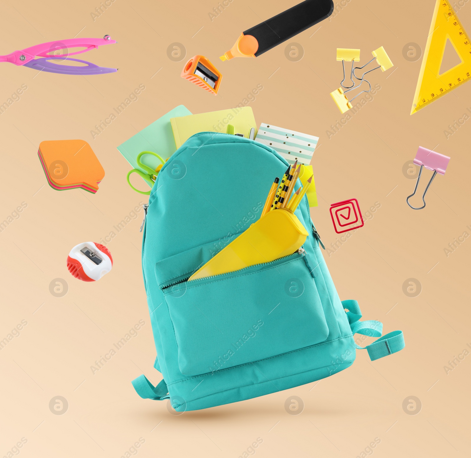 Image of Backpack surrounded by flying school stationery on pale orange background