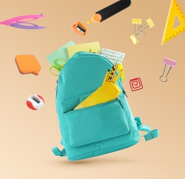 Backpack surrounded by flying school stationery on pale orange background