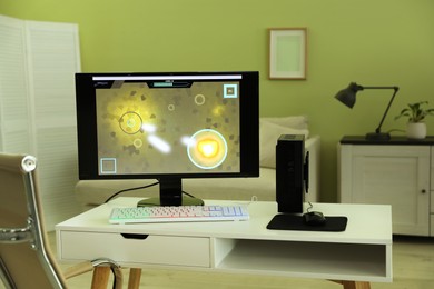 Modern computer and RGB keyboard on white table indoors