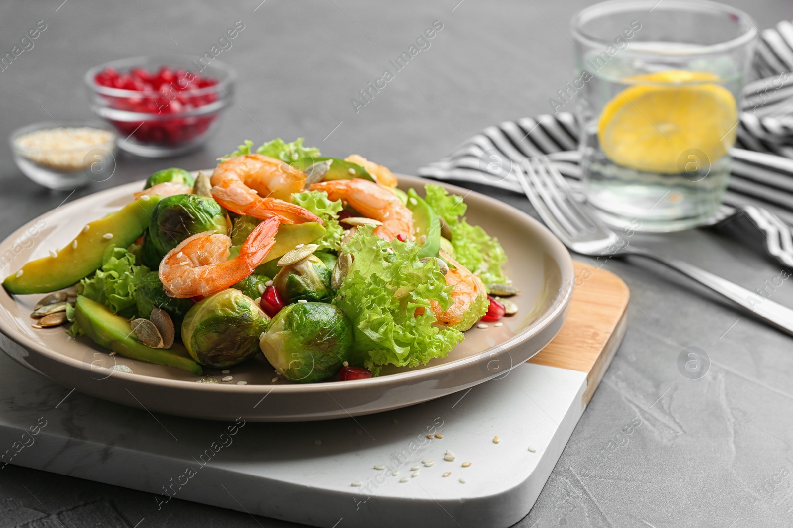 Photo of Tasty salad with Brussels sprouts served on grey table