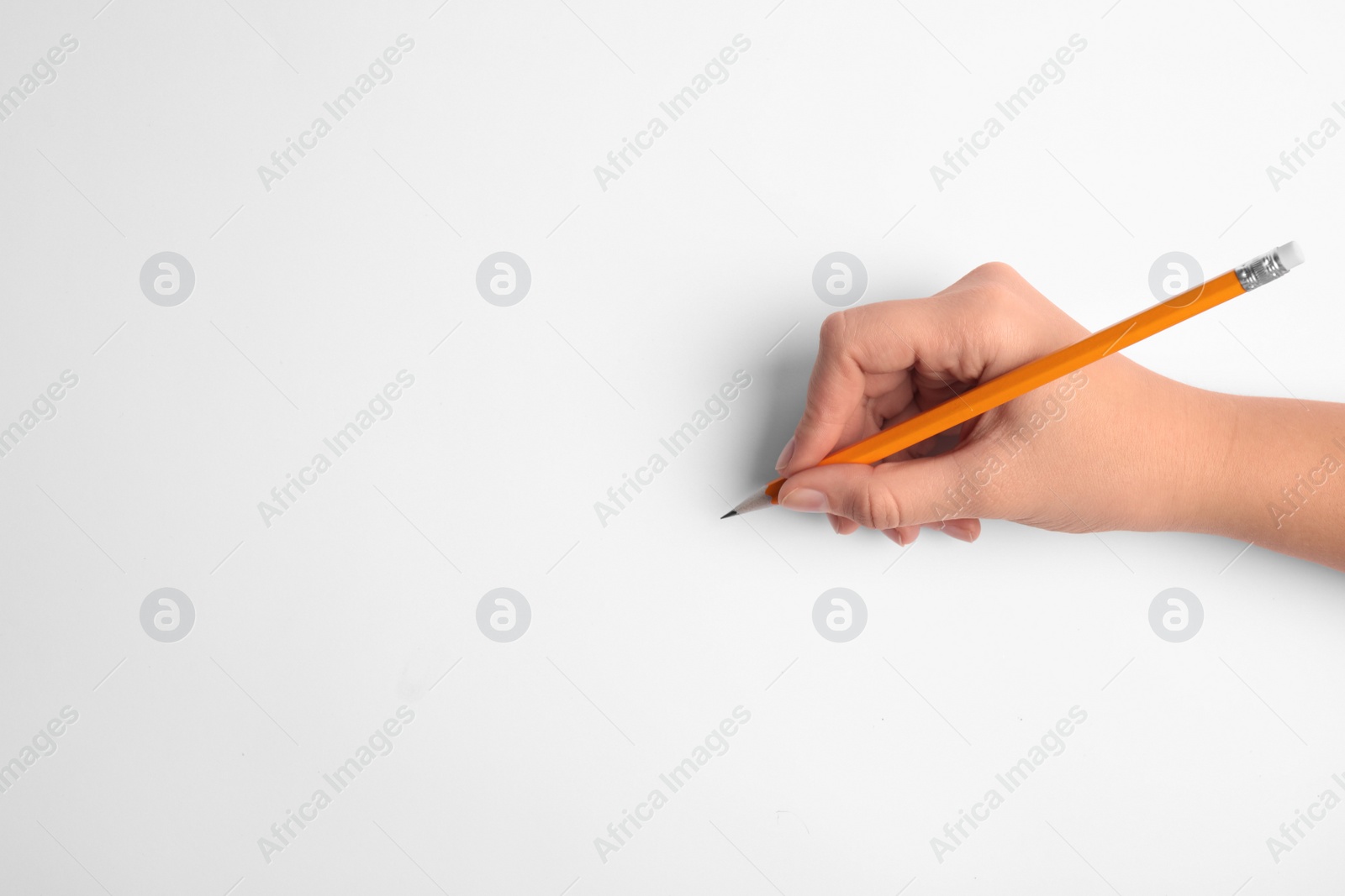 Photo of Woman holding pencil on white background, top view