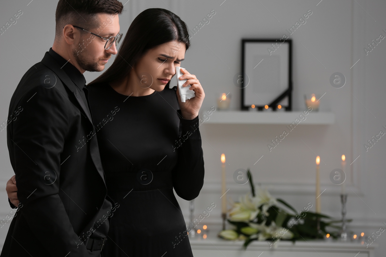 Photo of Sad couple mourning indoors, space for text. Funeral ceremony