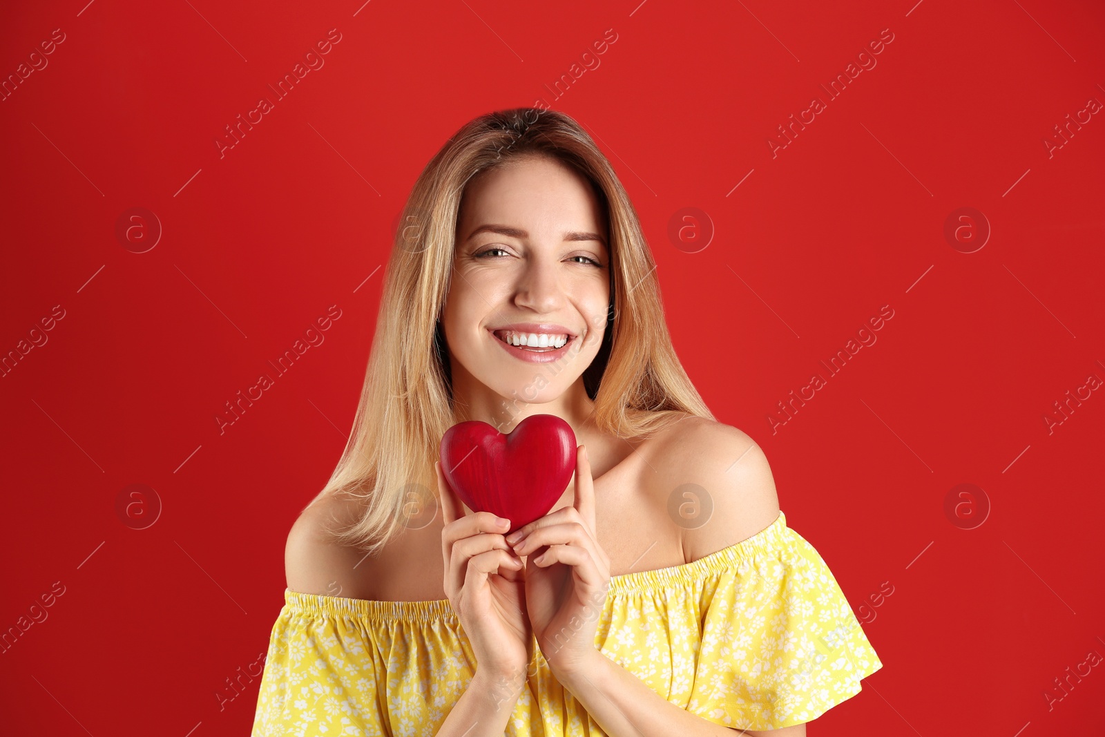 Photo of Portrait of woman with decorative heart on color background