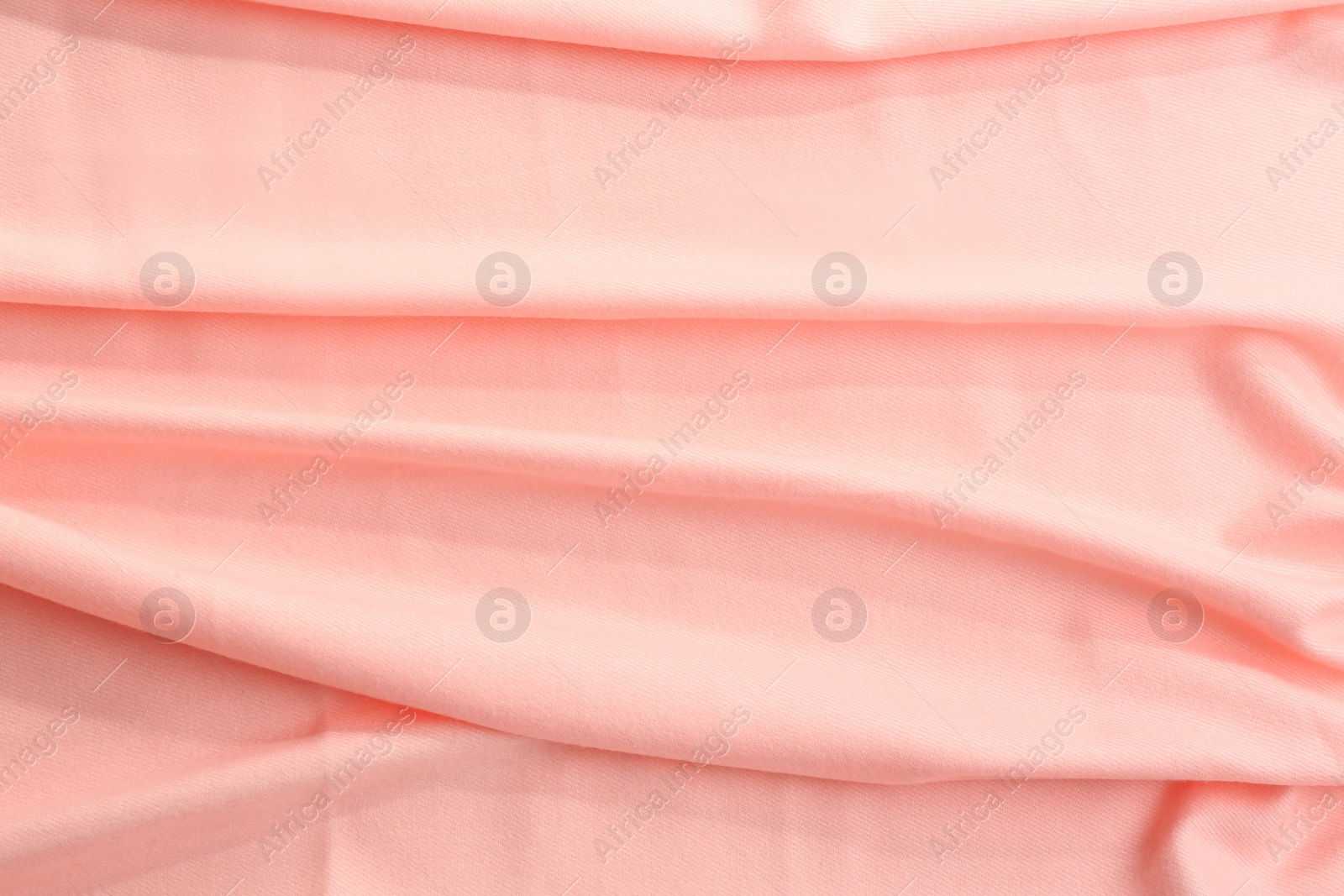 Photo of Elegant peach cloth as background, closeup view