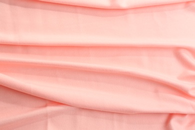 Elegant peach cloth as background, closeup view