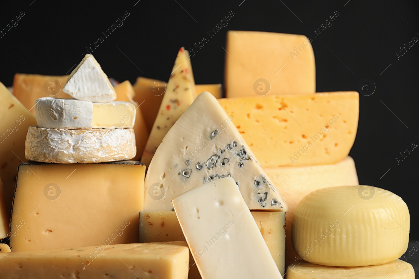 Photo of Many different types of delicious cheese, closeup