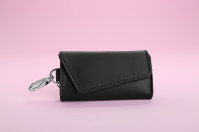 Photo of Stylish leather keys holder on pink background