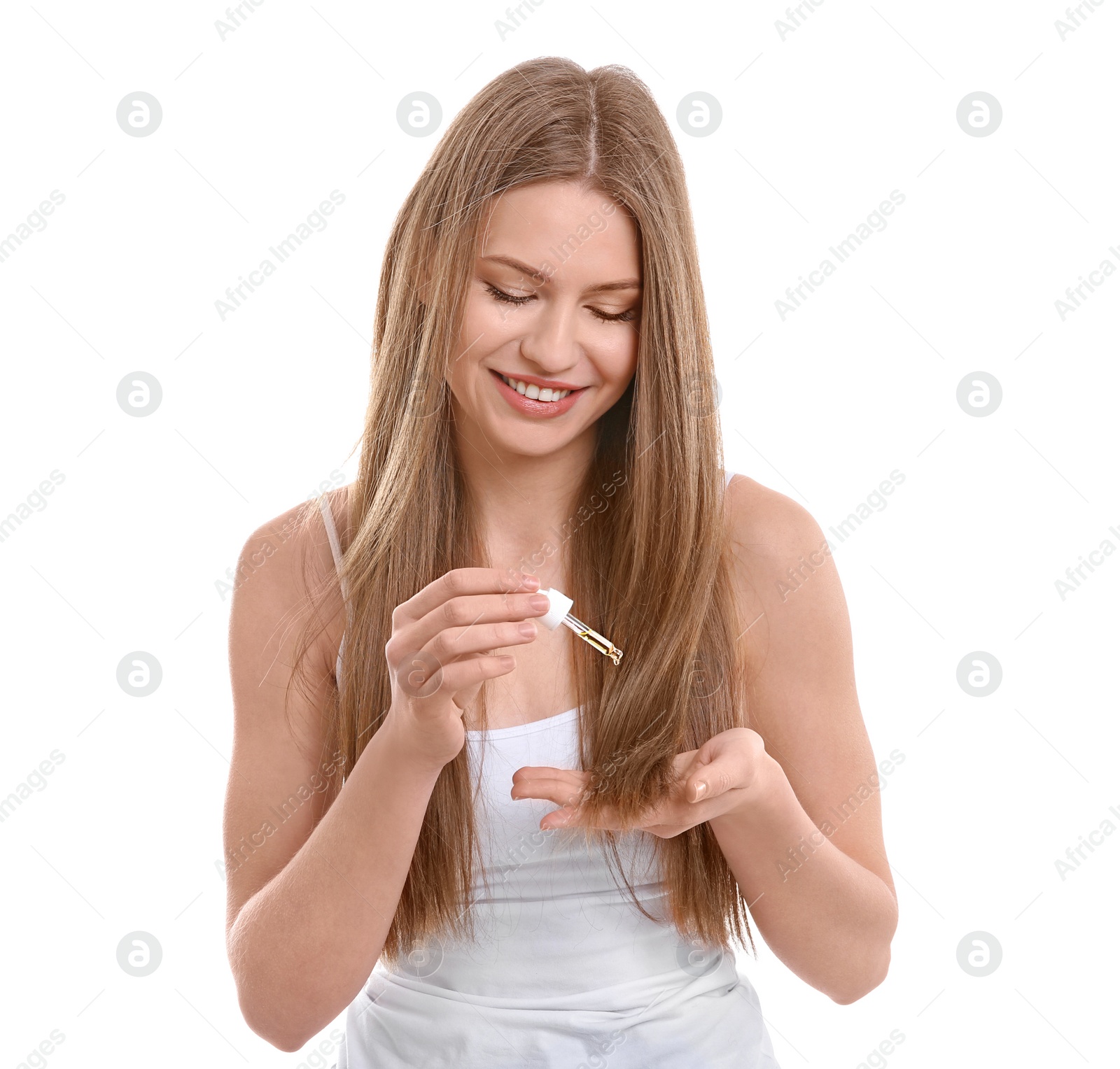 Photo of Young woman applying oil onto hair on white background