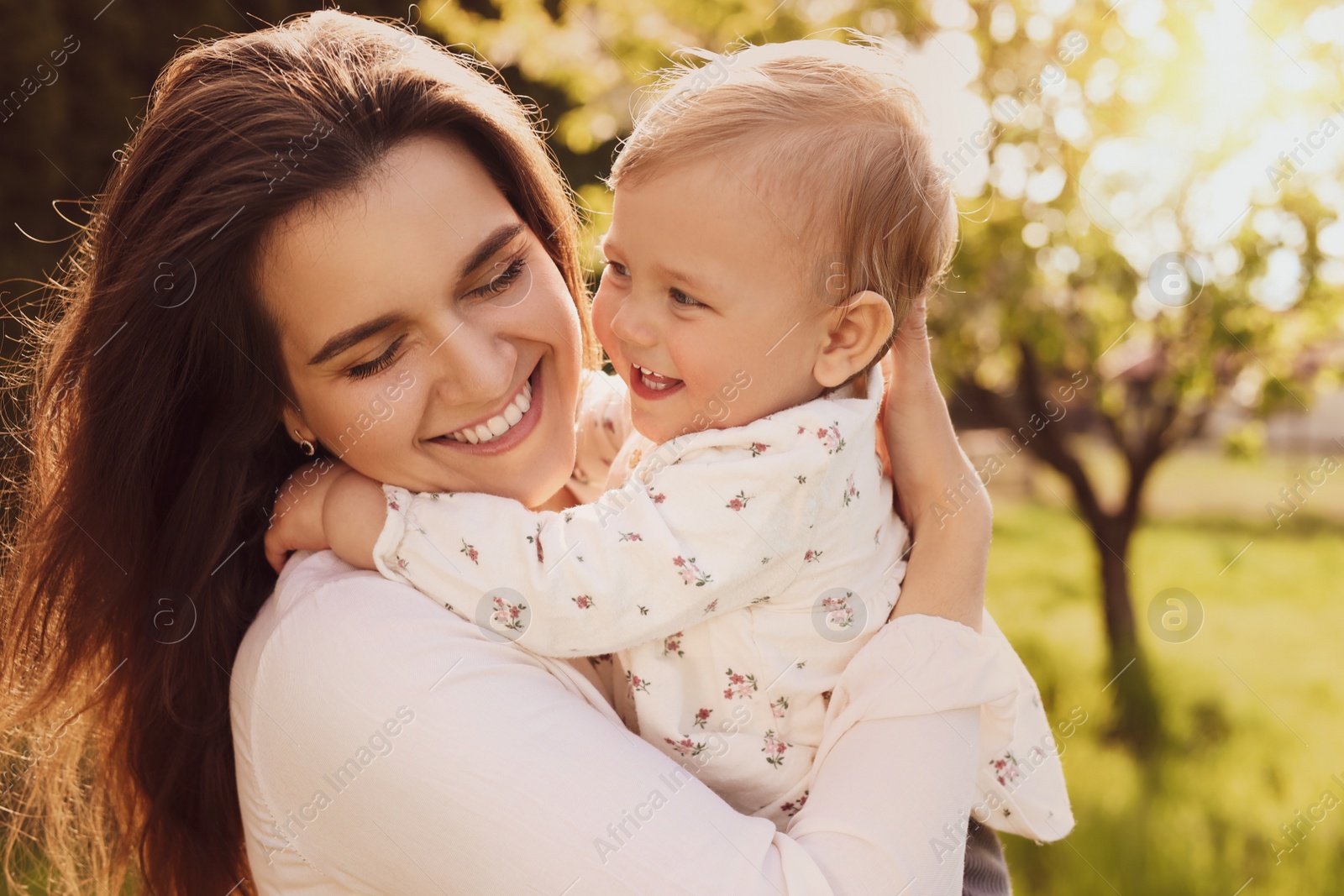 Image of Happy mother with her cute baby in park on sunny day