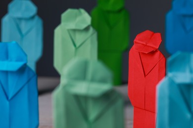 Photo of Many colorful paper figures on table, closeup. Recruiter searching employee