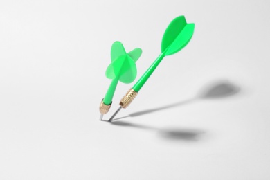 Photo of Green dart arrows for game on white background