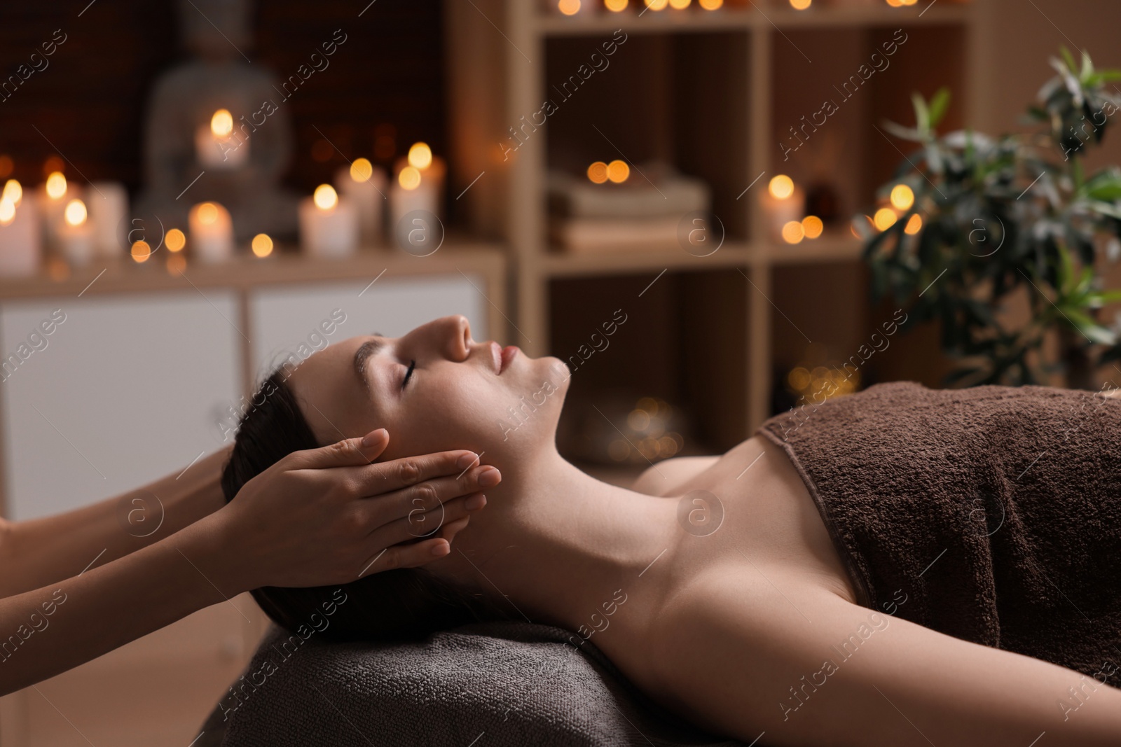 Photo of Spa therapy. Beautiful young woman lying on table during massage in salon