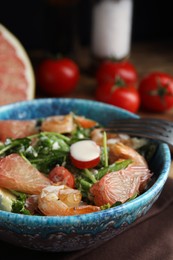 Photo of Delicious pomelo salad with shrimps served on table, closeup