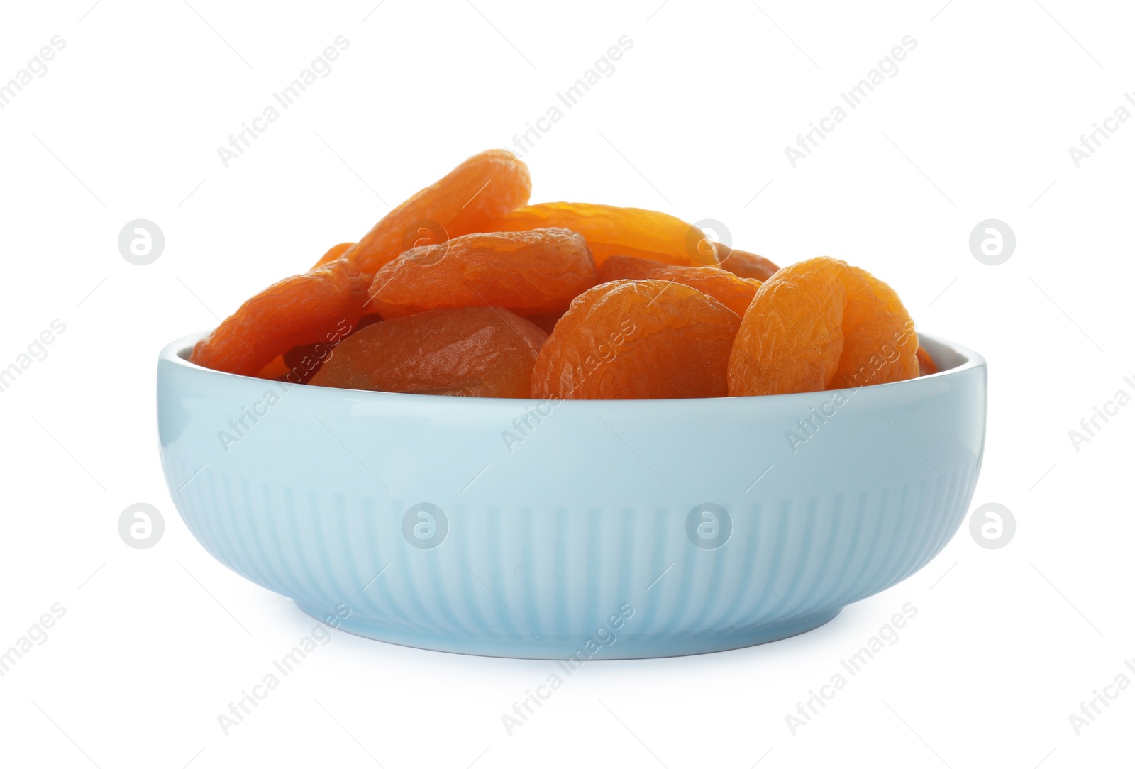 Photo of Bowl with apricots on white background. Dried fruit as healthy food