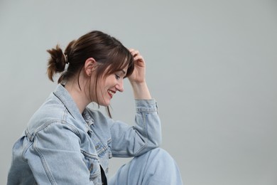 Photo of Portrait of happy woman on grey background