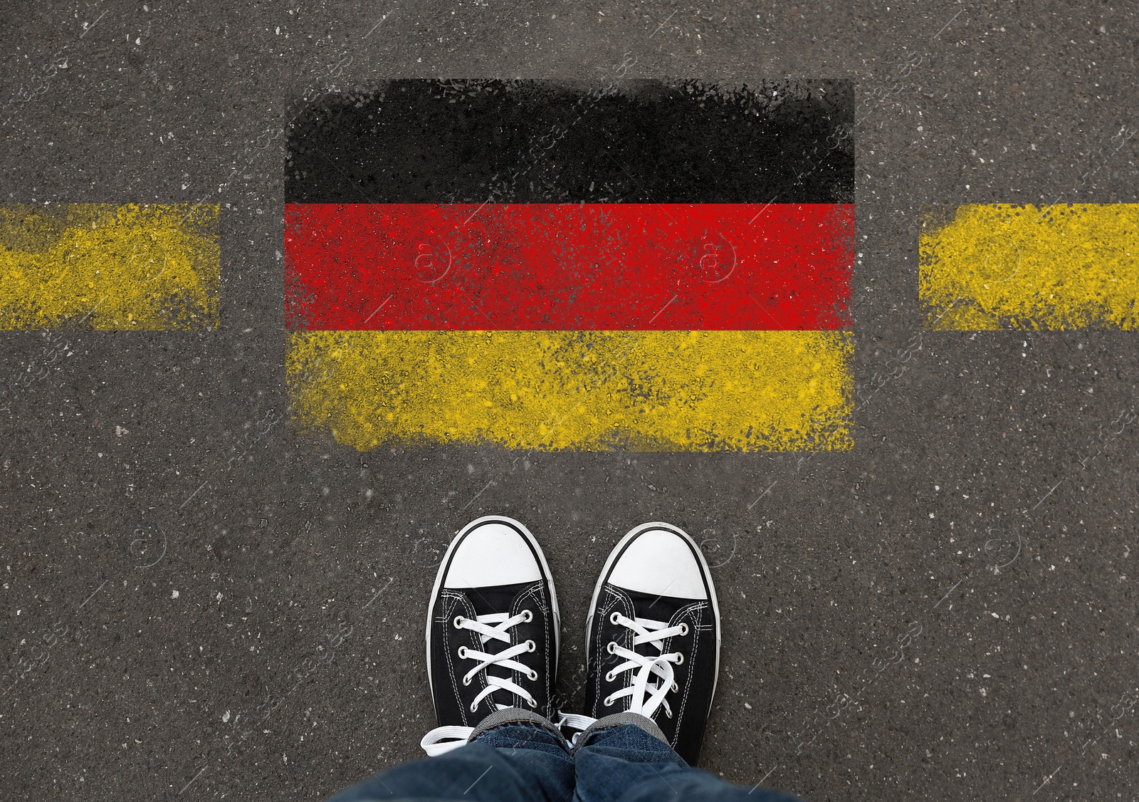 Image of Immigration. Woman standing on asphalt near flag of Germany, top view