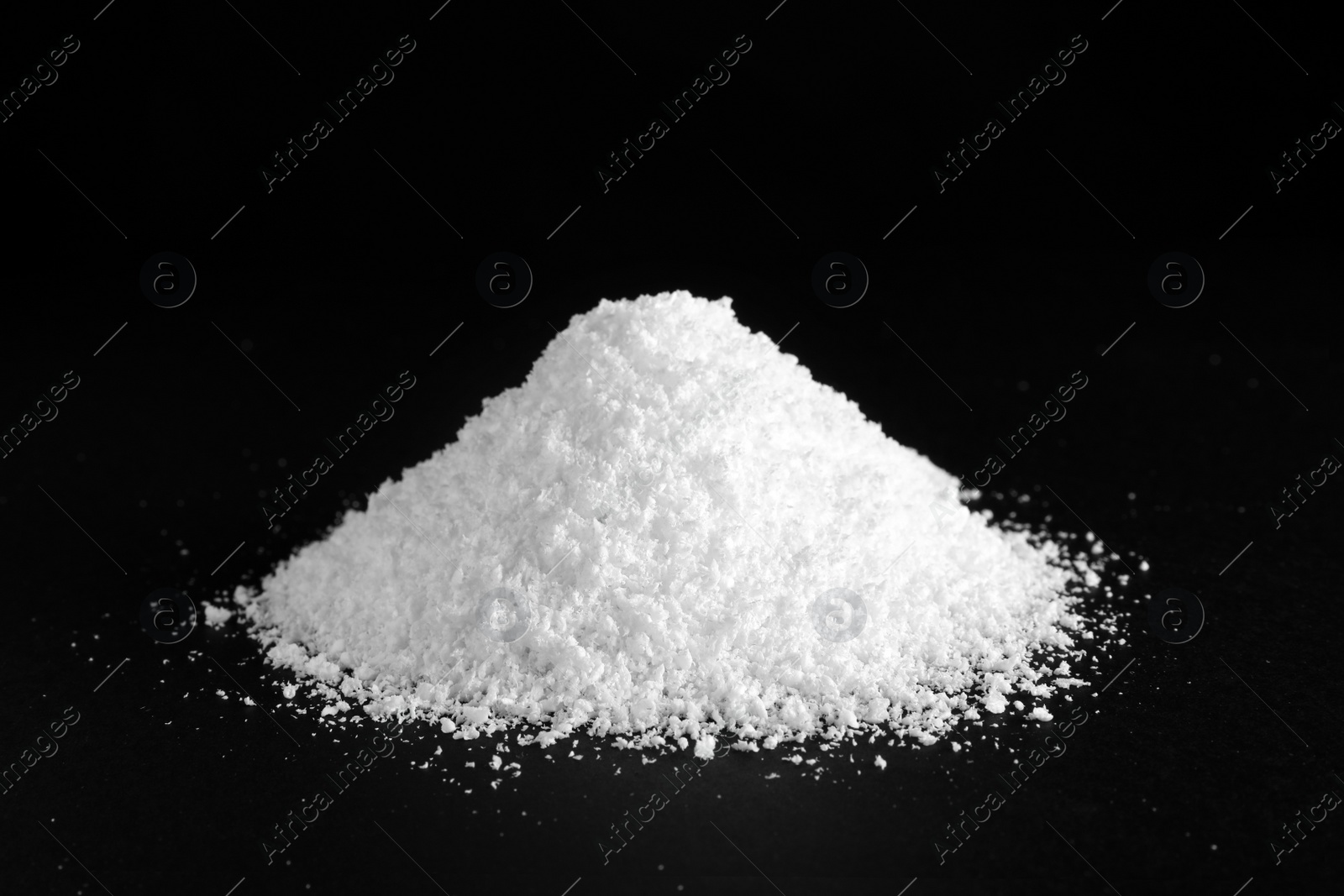 Photo of Heap of white snow on black background