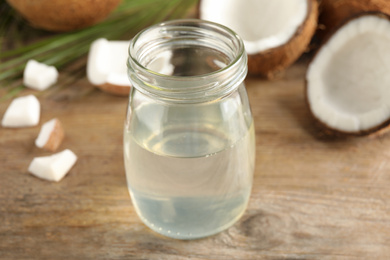 Coconut oil on wooden table, closeup view