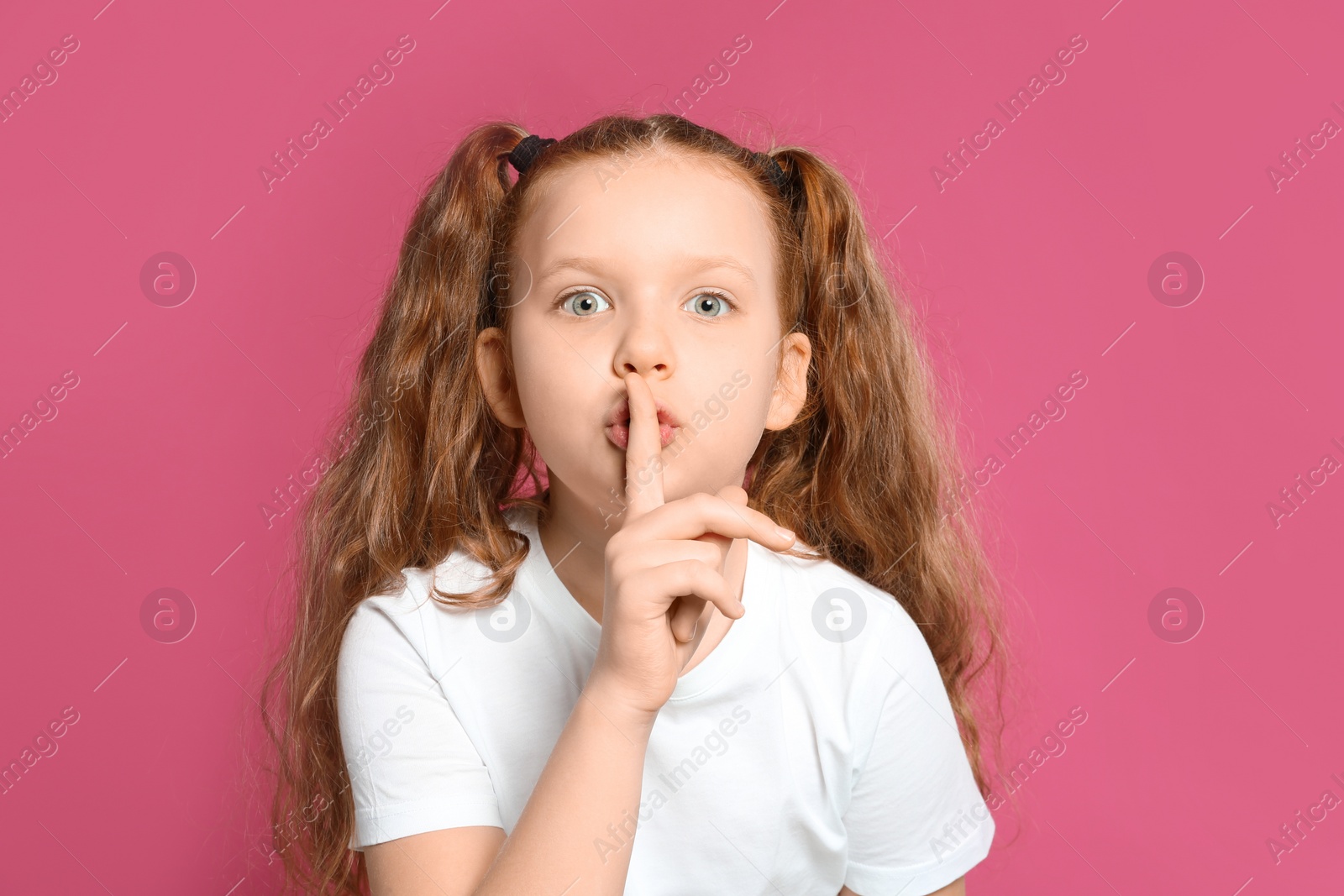 Photo of Portrait of emotional girl on pink background