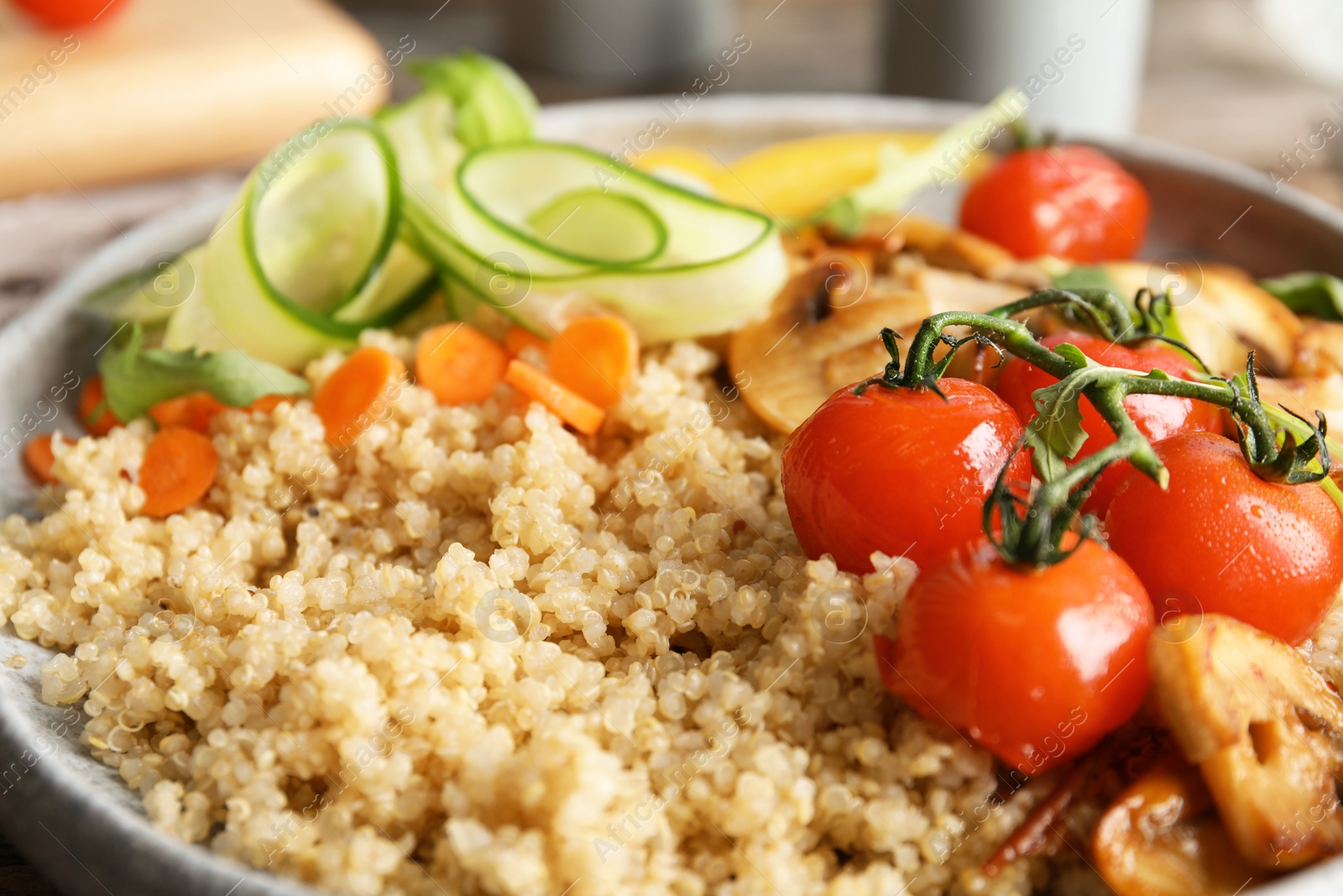 Photo of Plate with healthy quinoa salad and vegetables, closeup