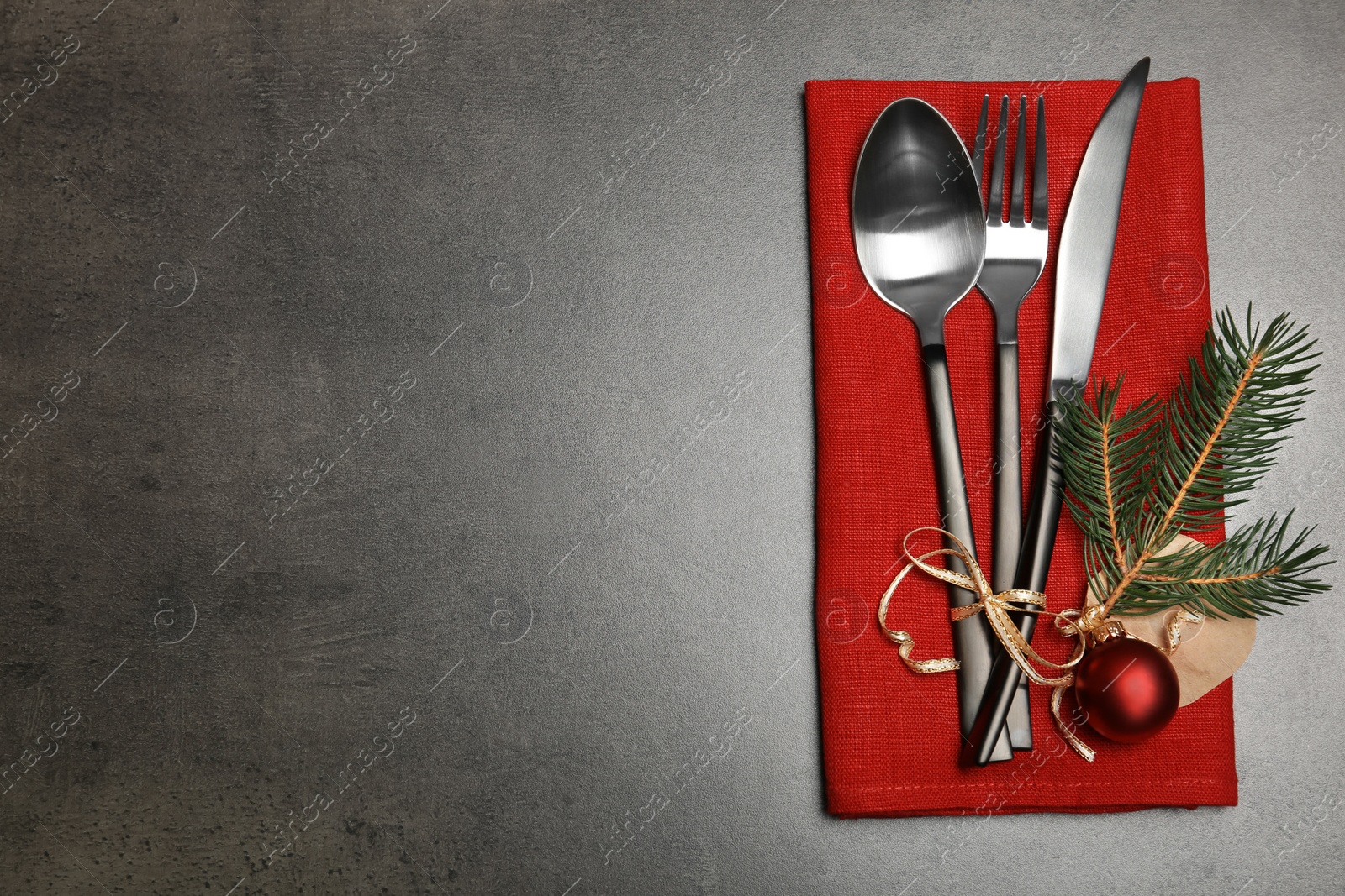 Photo of Cutlery and napkin on gray background, top view. Table setting