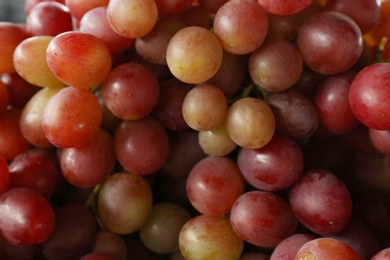 Fresh ripe juicy red grapes as background, closeup view