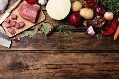 Fresh borscht ingredients on wooden table, flat lay. Space for text