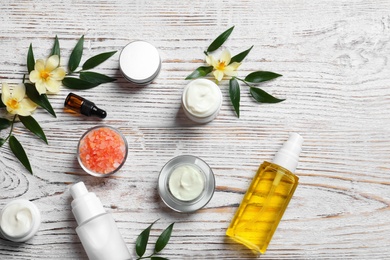 Photo of Flat lay composition with cosmetic products on wooden background