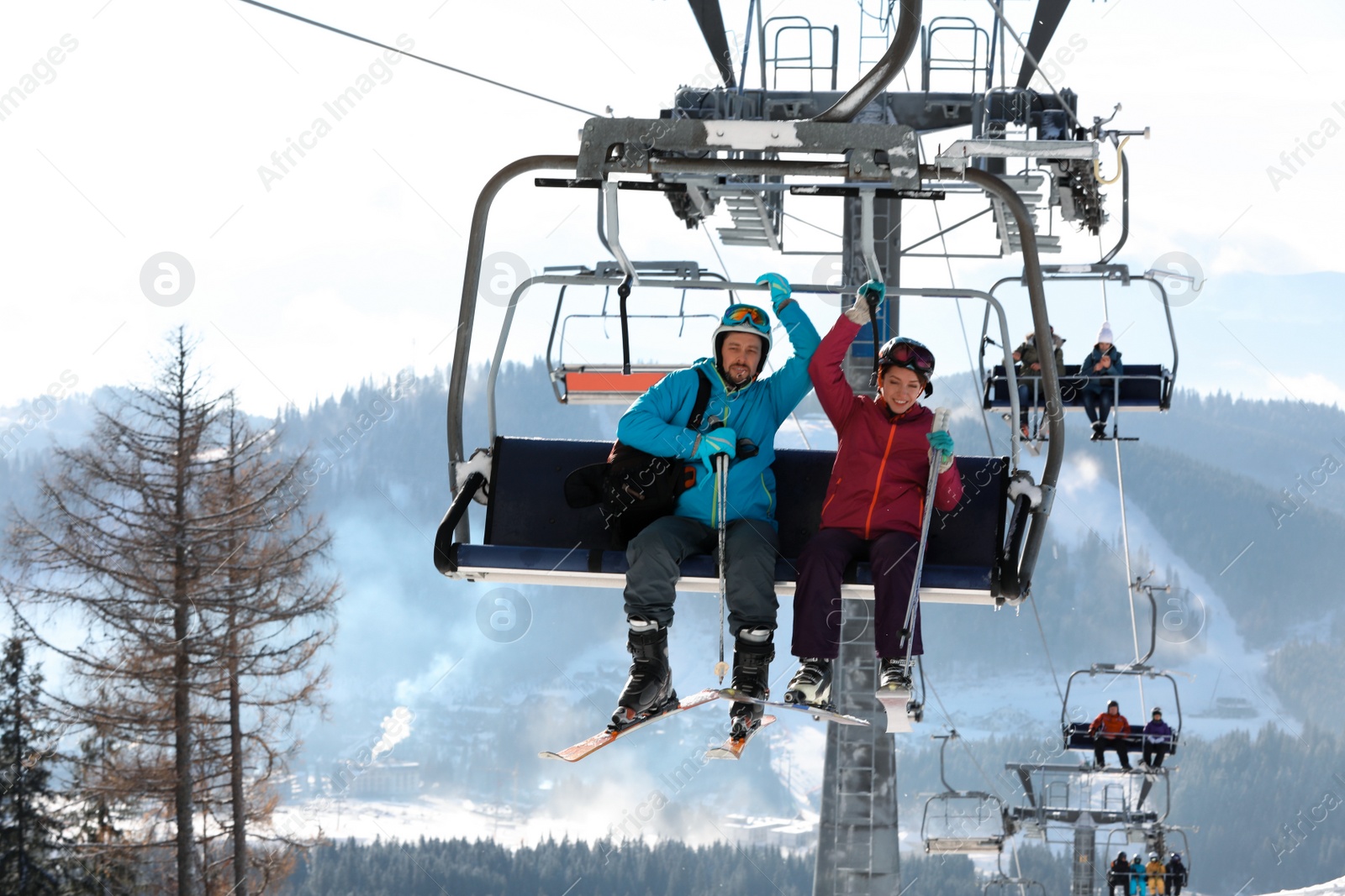 Photo of People using chairlift at mountain ski resort. Winter vacation