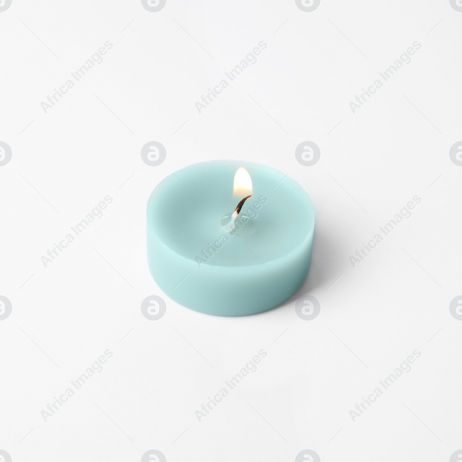 Photo of Light blue wax decorative candle isolated on white