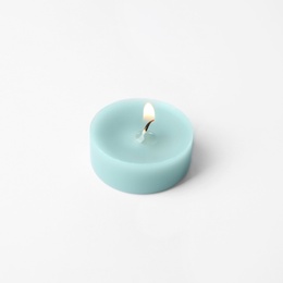 Photo of Light blue wax decorative candle isolated on white