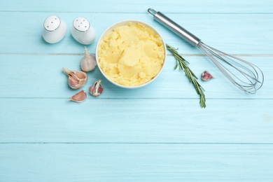 Photo of Flat lay composition with mashed potatoes and space for text on blue wooden background