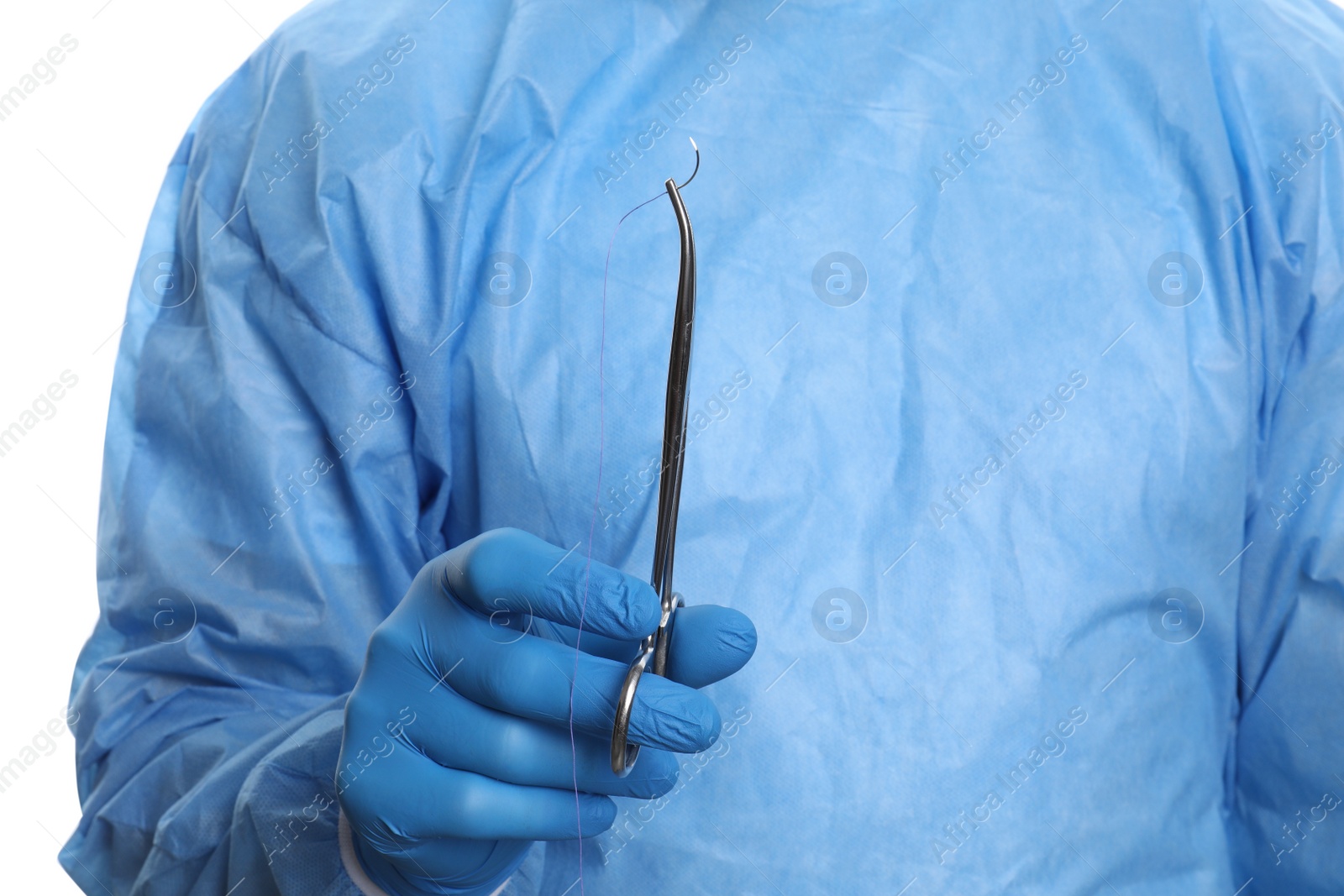 Photo of Doctor holding forceps with suture thread on white background, closeup. Medical equipment