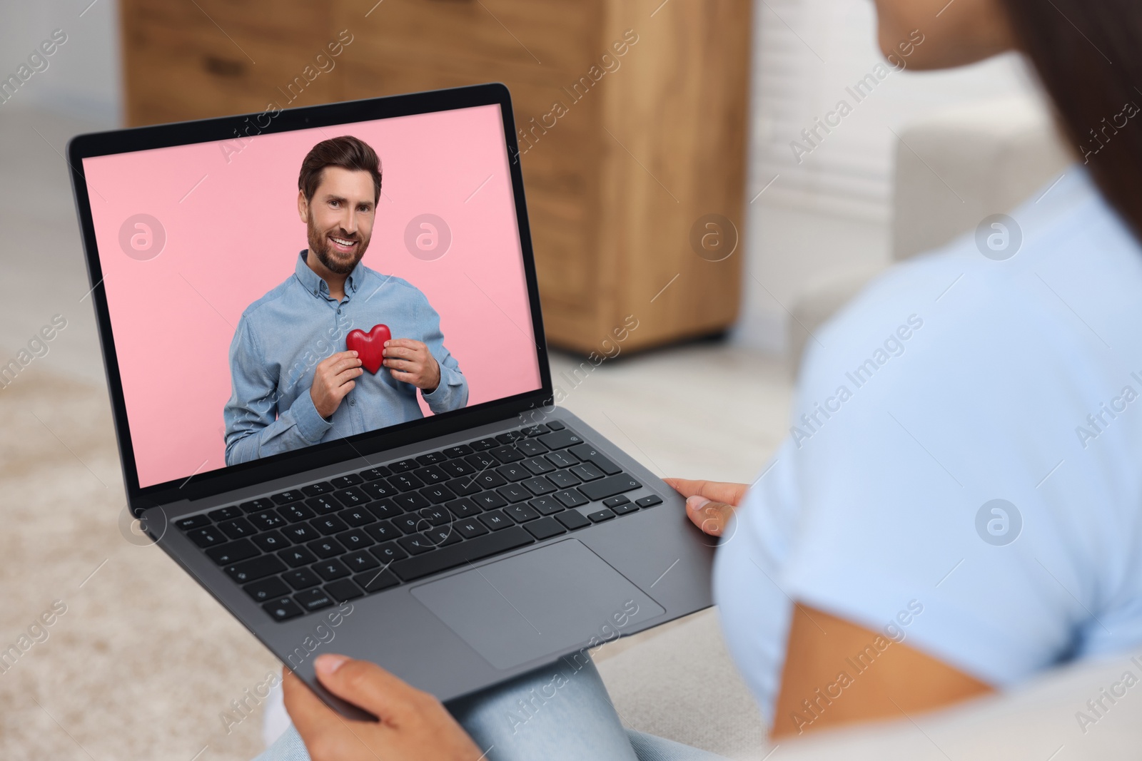 Image of Long distance love. Woman having video chat with her boyfriend via laptop at home, closeup