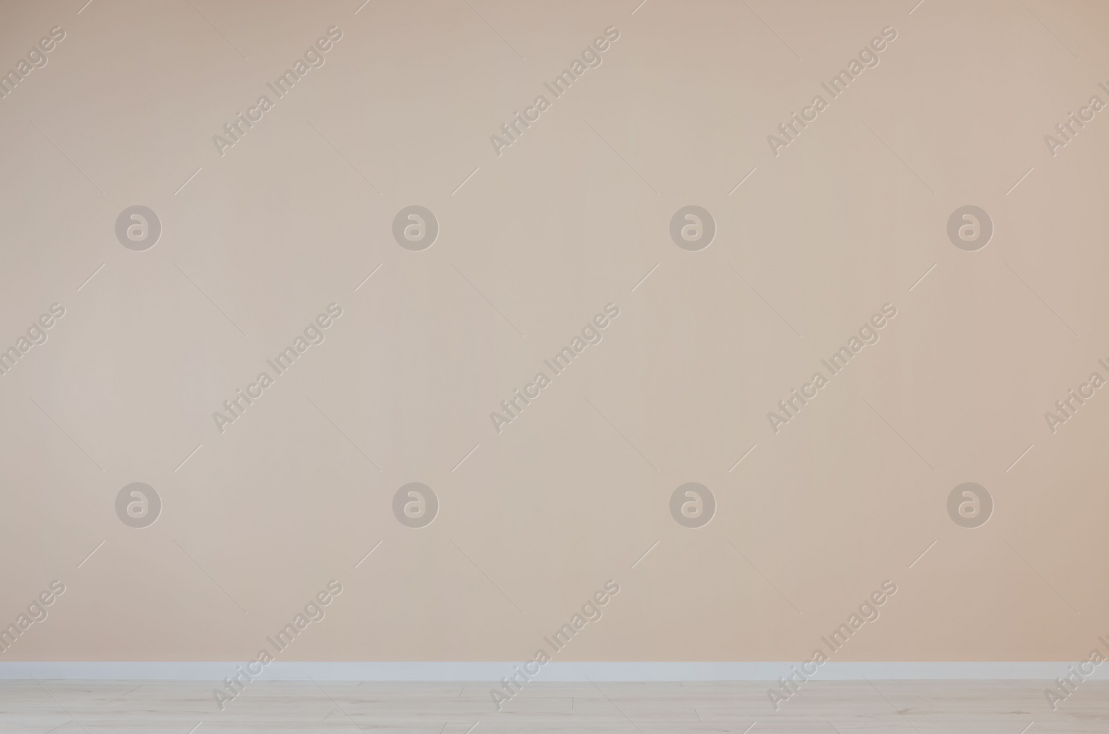 Photo of Pale orange wall with power outlet sockets in empty room
