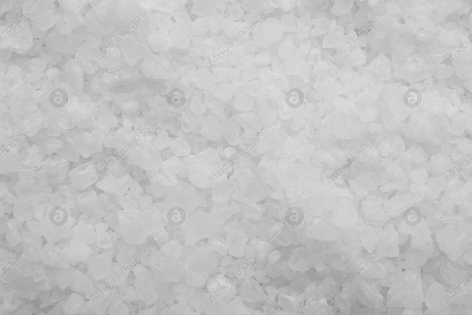 Photo of White sea salt as background, top view