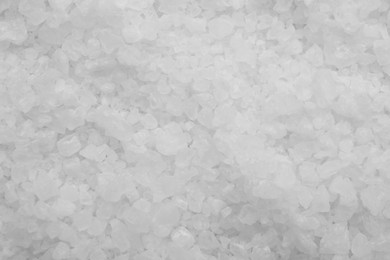 Photo of White sea salt as background, top view