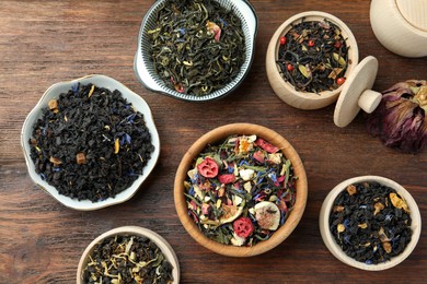 Many different herbal teas on wooden table, flat lay