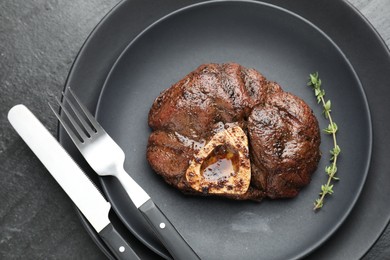 Tasty grilled beef meat served on black table, top view