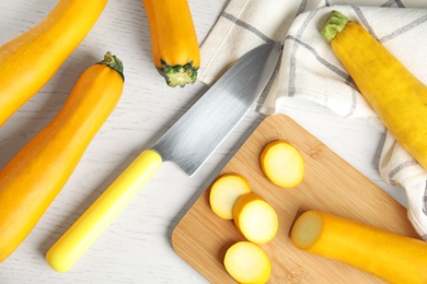 Photo of Flat lay composition with fresh ripe yellow zucchinis on white wooden table