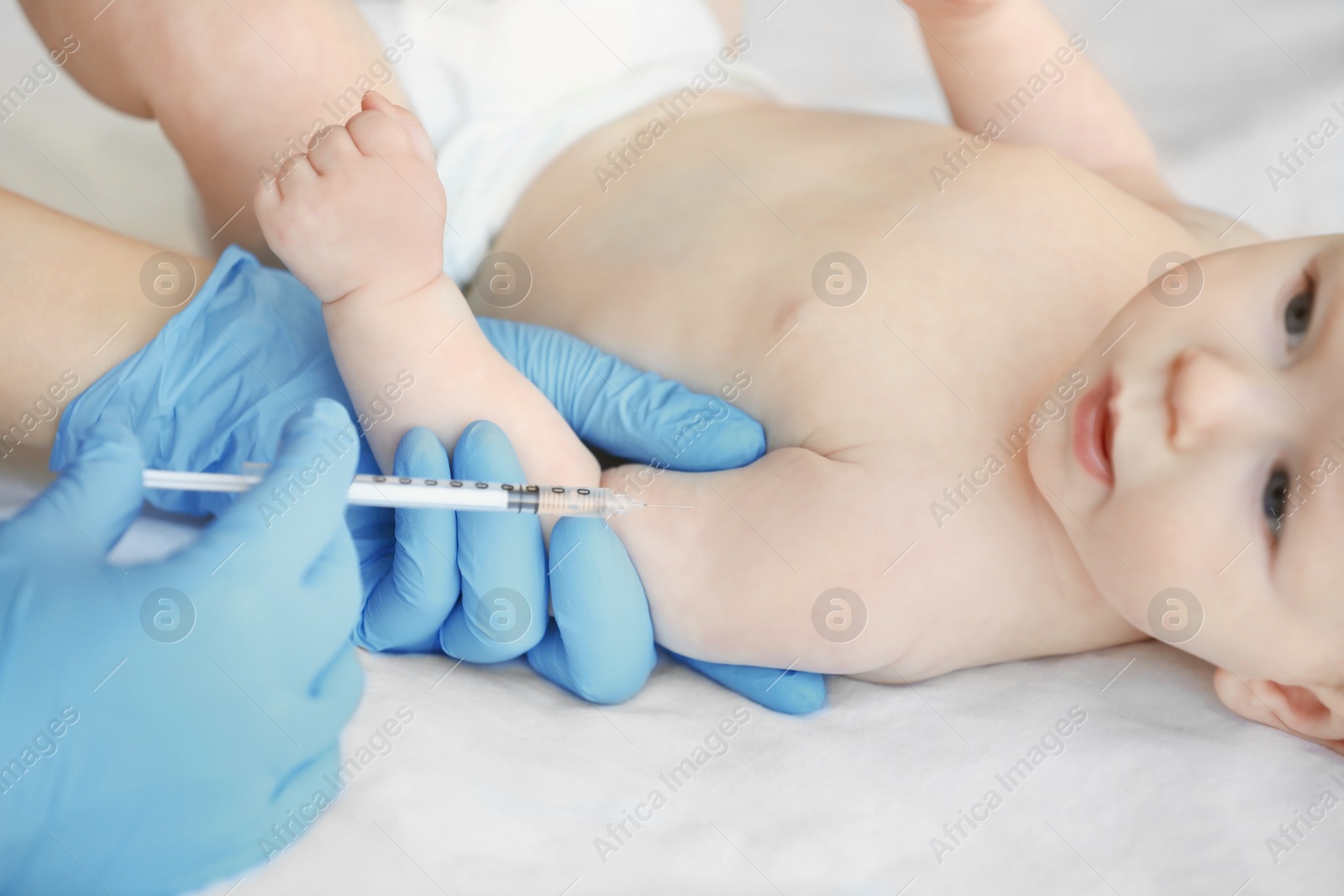 Photo of Doctor vaccinating baby in clinic