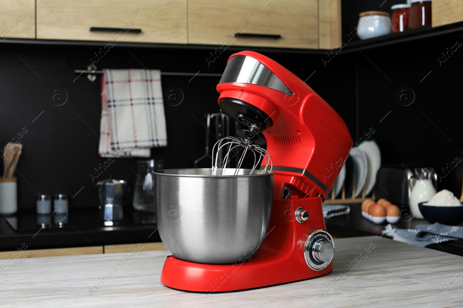 Photo of Modern stand mixer on wooden table in kitchen. Home appliance