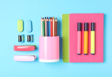 Photo of Different stationery on light blue background, flat lay. Back to school