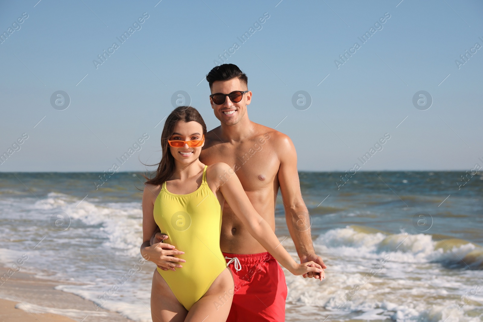 Photo of Lovely couple spending time together on beach