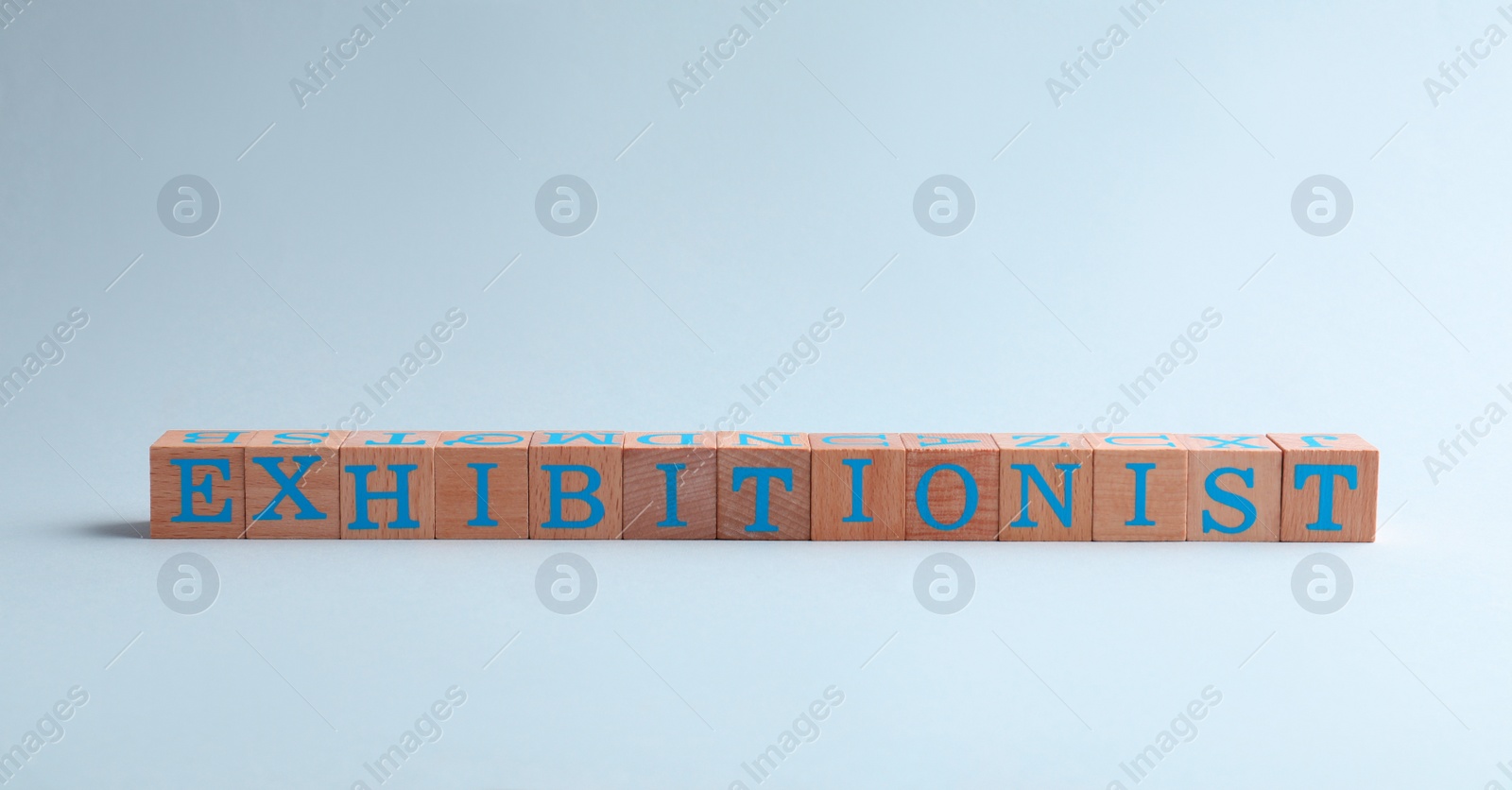 Photo of Word EXHIBITIONIST made with wooden cubes on white background