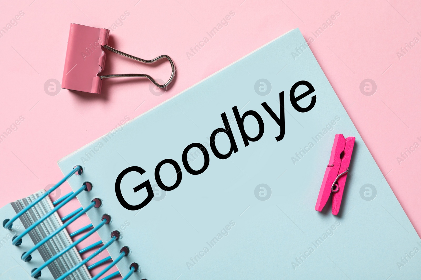 Image of Notebook with text Goodbye on pink background, flat lay