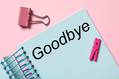 Notebook with text Goodbye on pink background, flat lay